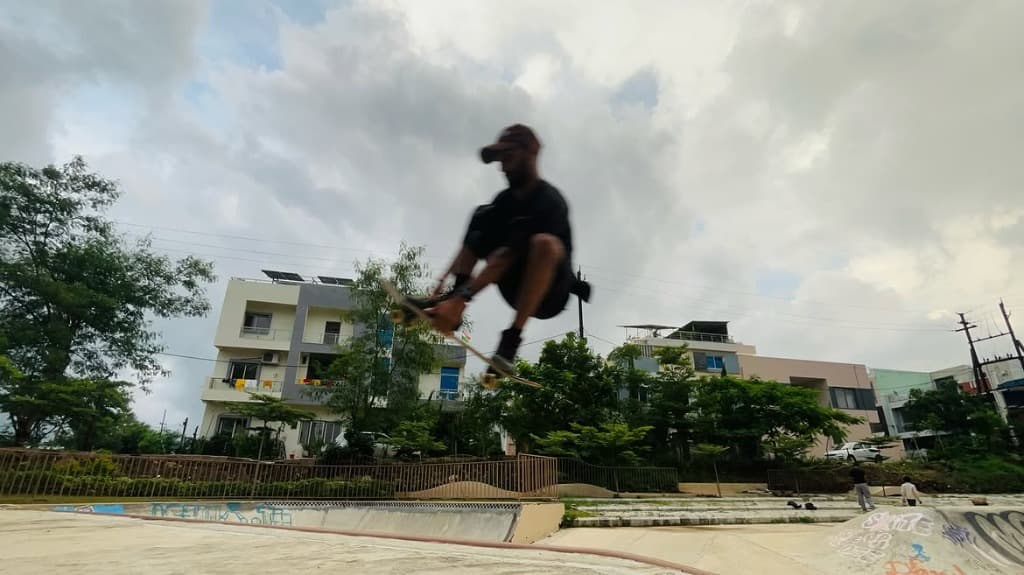BhopalSB Skater mid-air kickflip at street spot